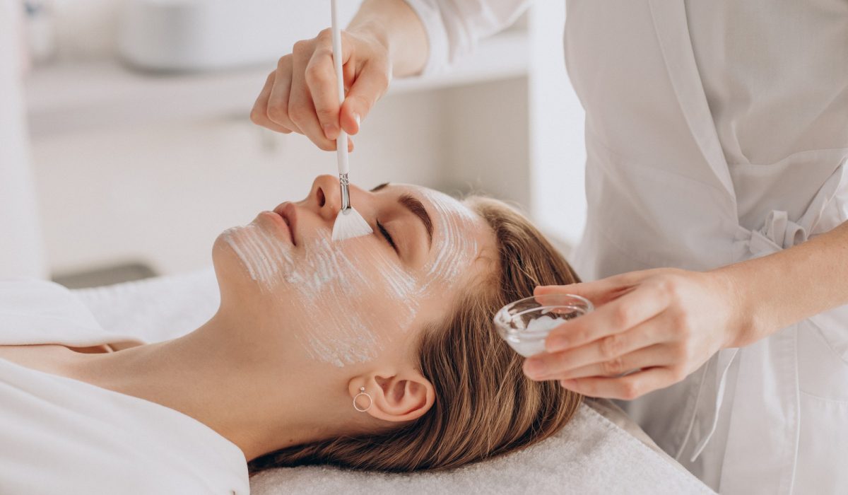 cosmetologist-doing-face-treatment-applying-face-mask
